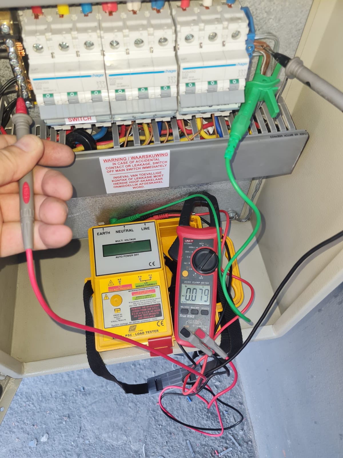 PSC and loop testing with a yellow tester and clamp meter on the distribution board