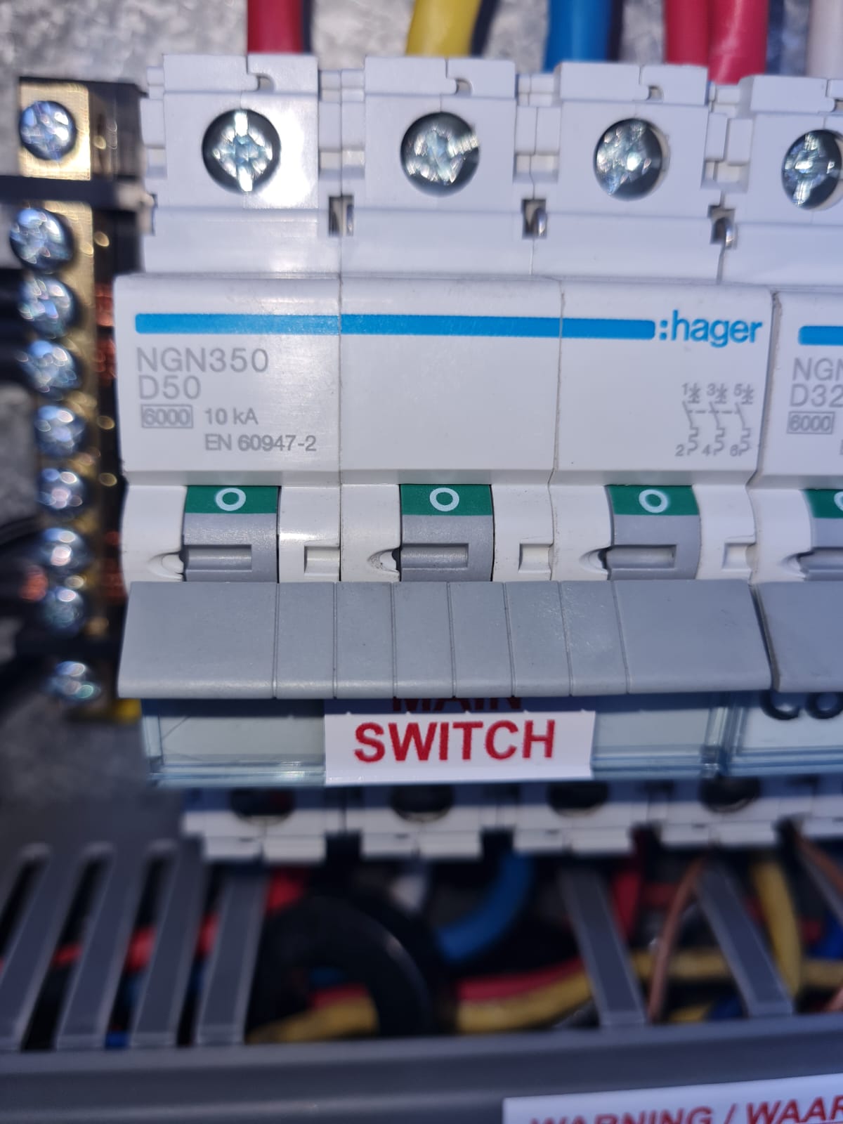 Close-up of a Hager main switch installed in the new distribution board